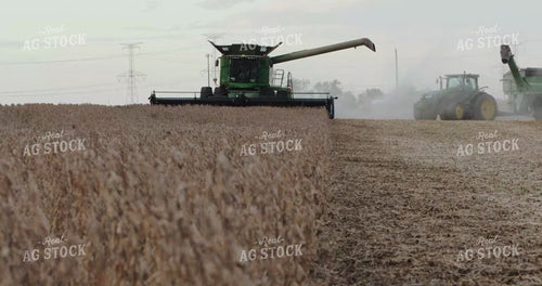 Combine Harvesting Soybeans while Grain Cart Pulls Alongside 3960