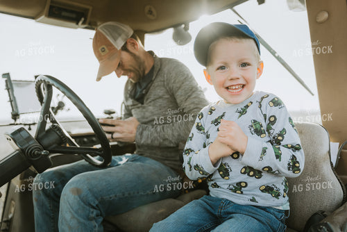 Farmer in Tractor Cab with Son 8189