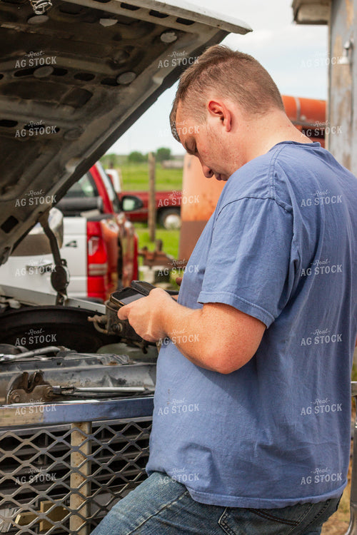 Farmer Repairing Truck Engine 155193