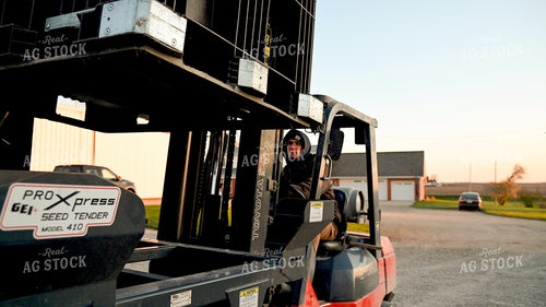 Farmer Loading the Seed Tender with a Skidsteer 25188