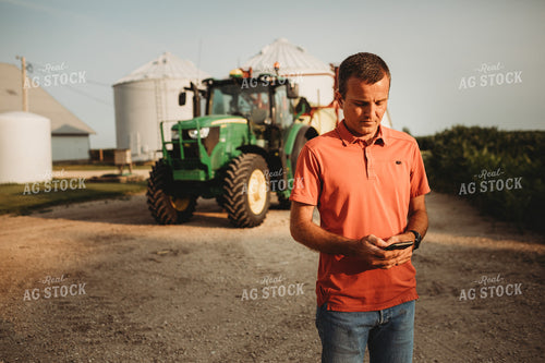 Farmer on Phone Outside of Tractor 4530
