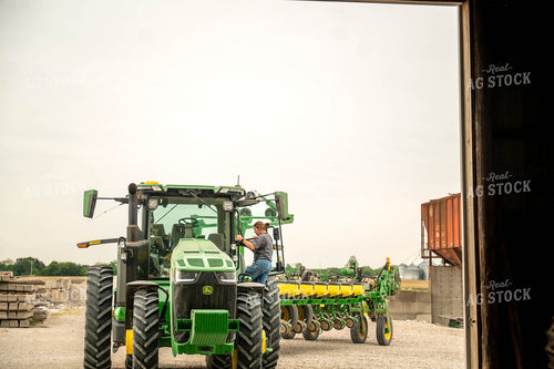 Female Farmer Climbing into Planter 115714