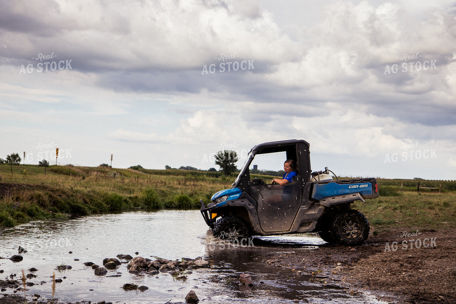 Farmer Driving Side by Side in Creek 67470