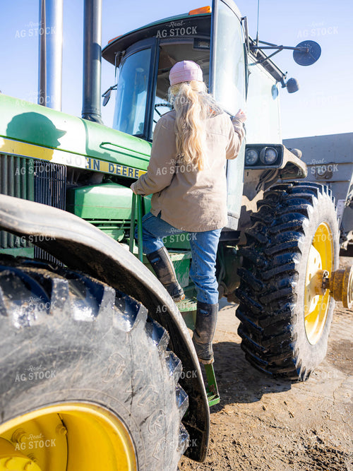 Rancher Getting Out of Tractor 70219