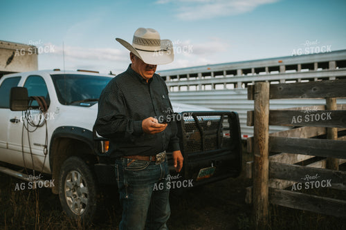 Rancher on Phone Near Pickup Truck 6492