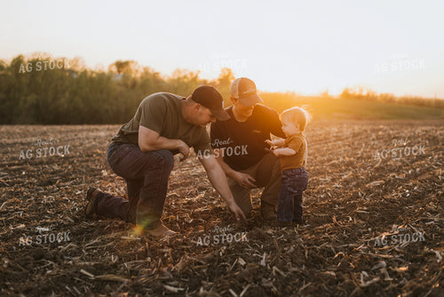 Young Farmers with Child Check Seed Depth After Planting 7714