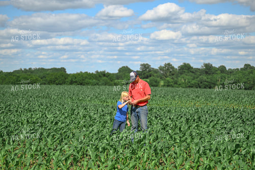 Farmer and Daughter Scouting Corn Field 191332
