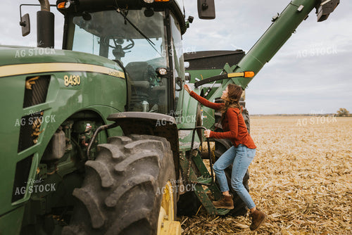 Female Farmer Cimbing into Tractor 8550