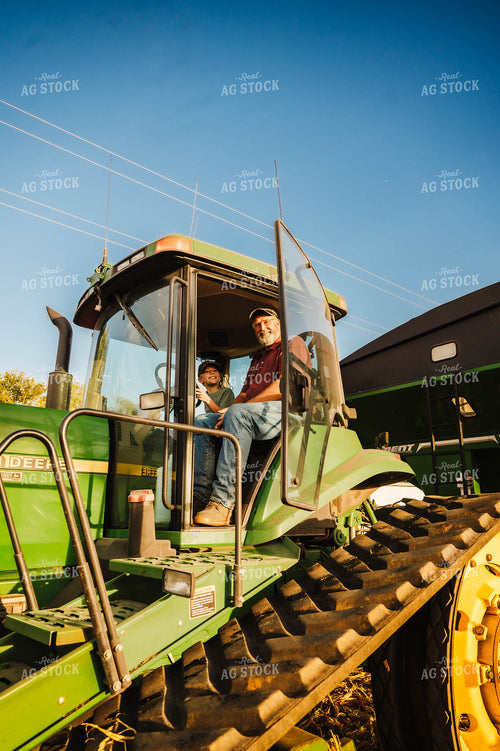 Farmer and Farm Kid Climbing into Tractor 115373