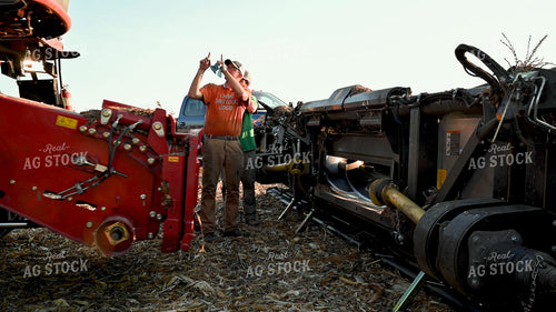 Farmer Directing Combine onto New Head 25522