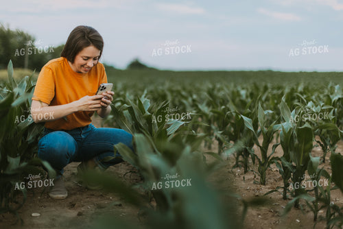 Female Farmer Takes Picture of Corn Plant 7840