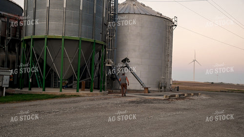 Farmer Working at Grain Bin Site during Harvest 25769