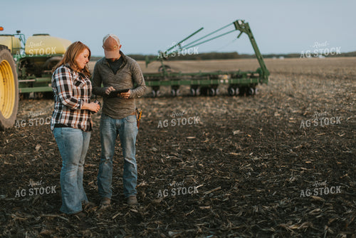 Farmers using Tablet in Field by Planter 8259