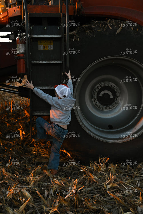 Farm Kid Climbing Out of Combine 26305