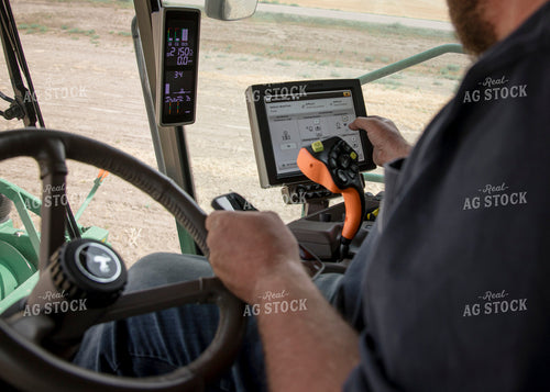 Farmer Using Combine Monitor 135030