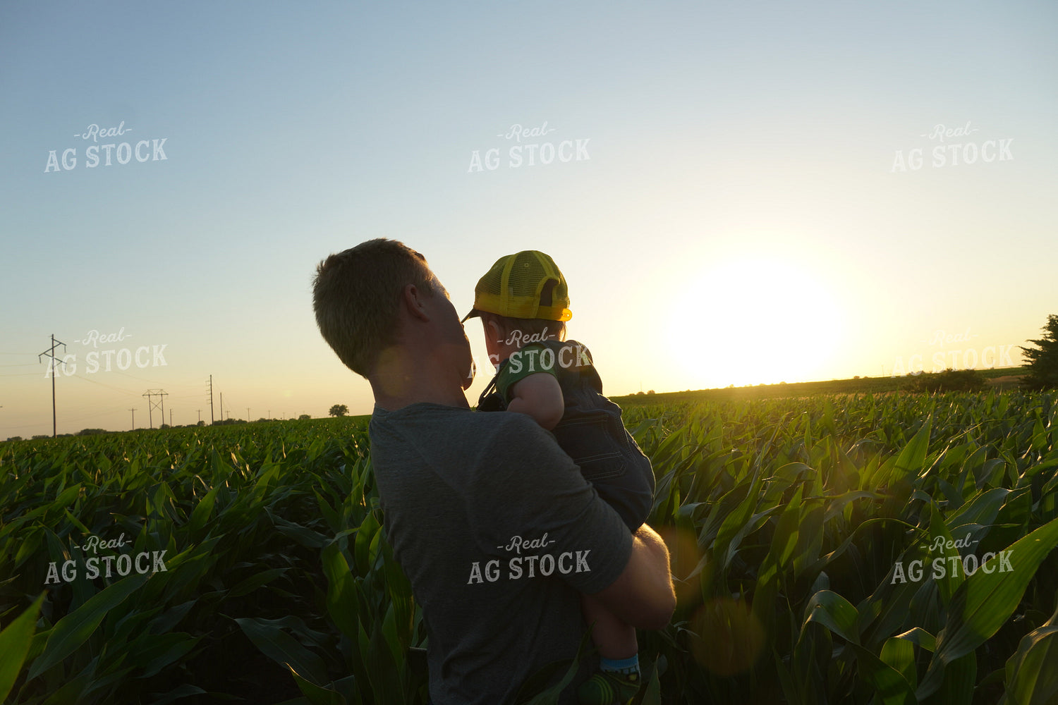 Farmer and Farm Kid in Corn Field at Sunset 65017