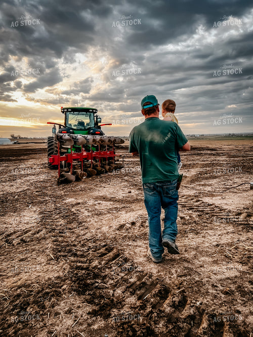Farmer Carrying Farm Kid to Tractor with Moldboard Plow 56391