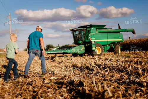 Farmer and Son in Field at Harvest 9363