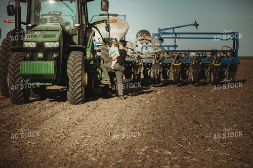 Farmer and Daughter Climbing into Tractor with Planter 4193