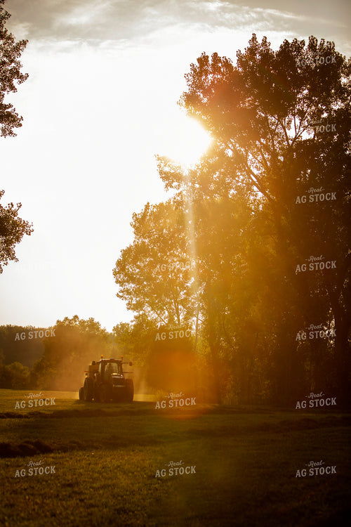 Tractor and Baler with Sun Coming through the Trees 5502