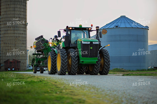 Farmers Drives Tractor and Planter in Farmyard 93212