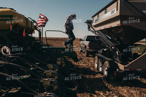Farmer Climbing Off of Planter with Seed Tender 4094