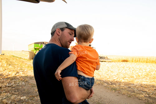 Family Enjoying Harvest Meal in the Field 25811