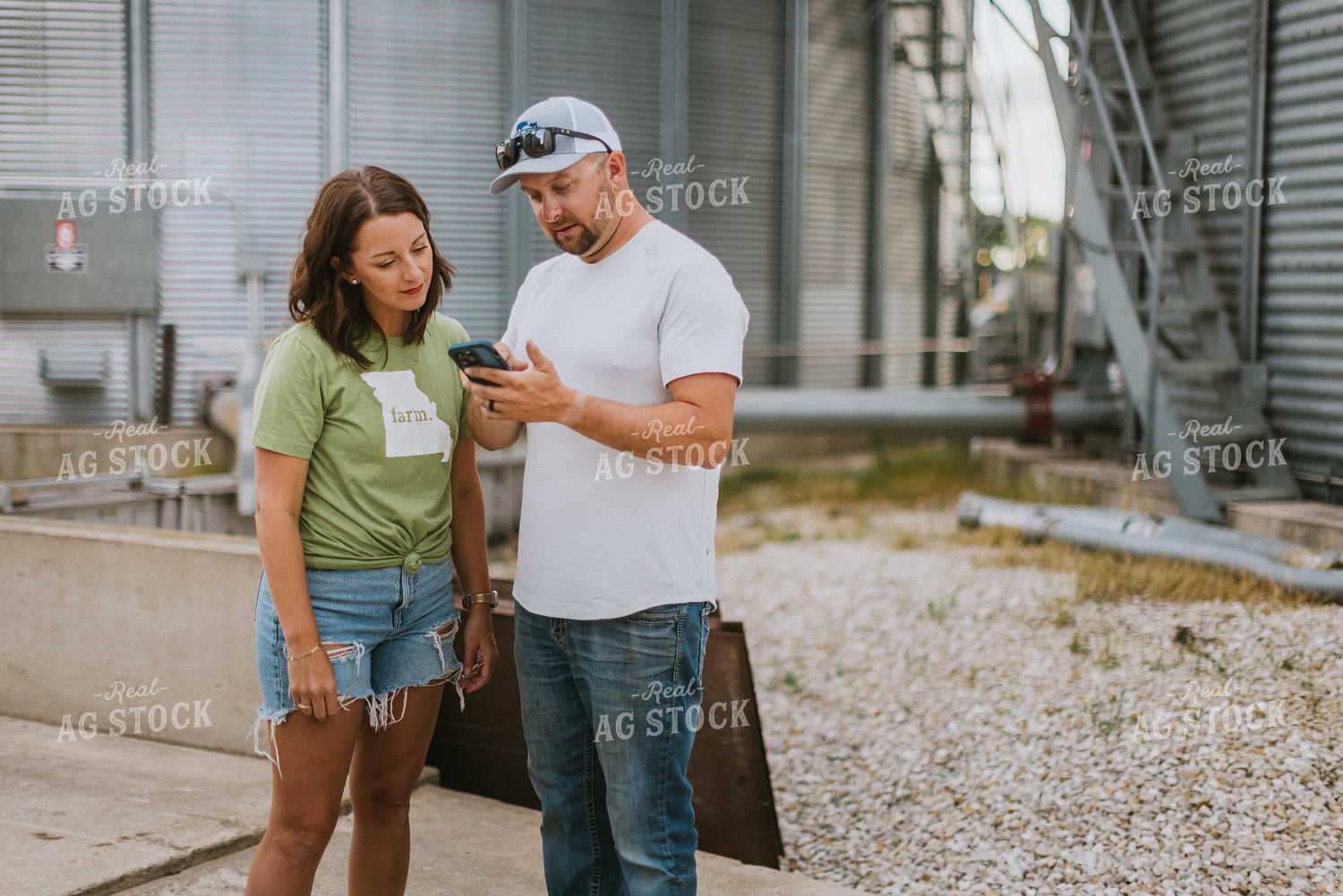 Farmer & Farm Wife Looking at Phone by Grain Bin 8762