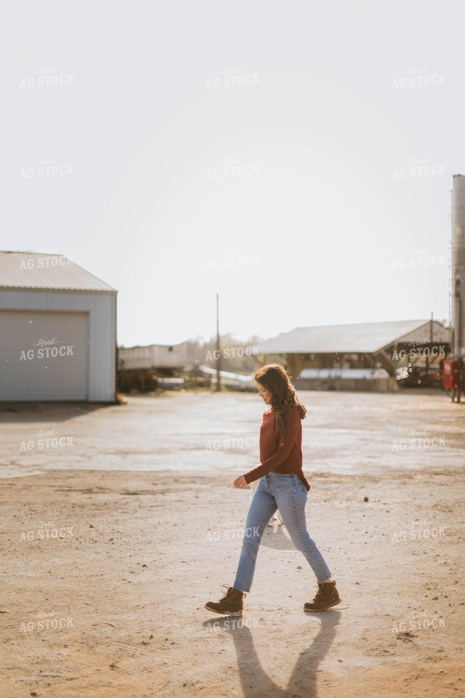 Female Farmer Walking by Grain Bins 8495