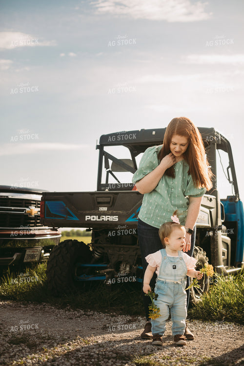 Farm Kid and Farm Wife next to UTV 4180