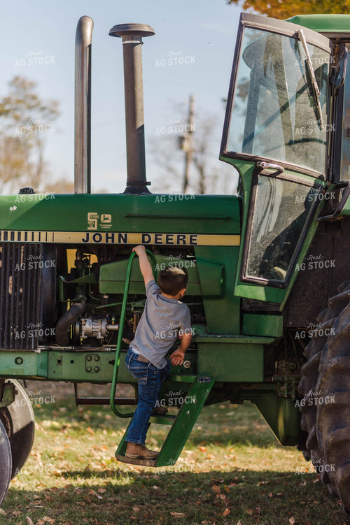 Farm Boy Climbing into Tractor 115018
