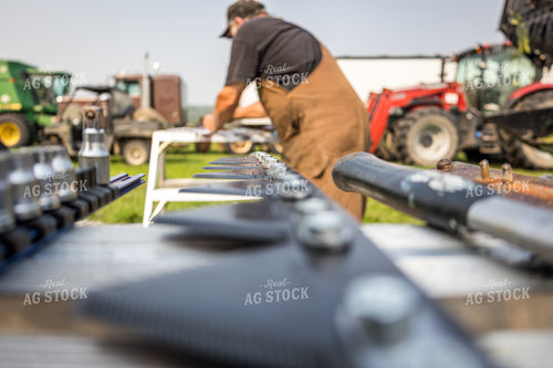 Farmer Fixing Swather 138095