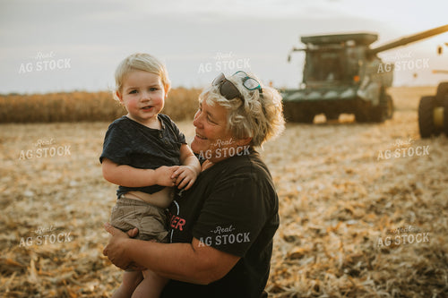 Farm Kid and Parent in Corn Field with Machinery 5269