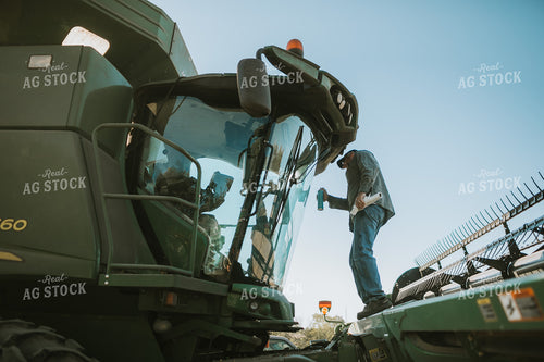 Farmer Cleaning Combine Windows 5222