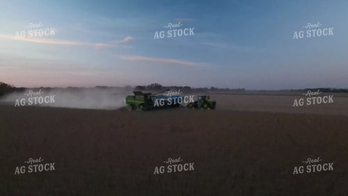 Aerial of Soybean Harvest with Tractor, Grain Cart, and Combine at Sunset 7384