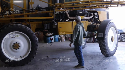 Farmer Guides Driver into Shed