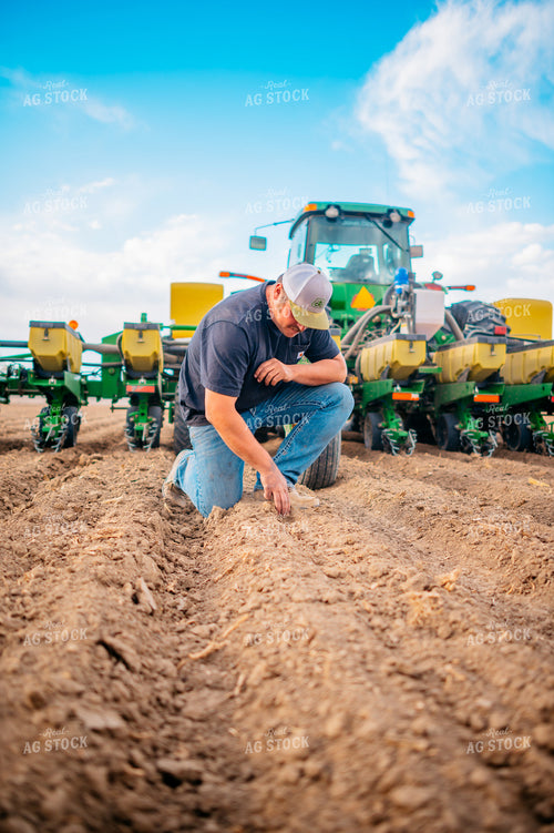 Farmer Checks Seed Depth Behind Planter 56649