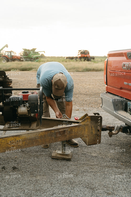 Farmer Hooking Up Trailer 125270