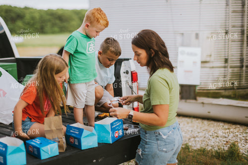 Farm Family Eating Dinner on the Tailgate 8756