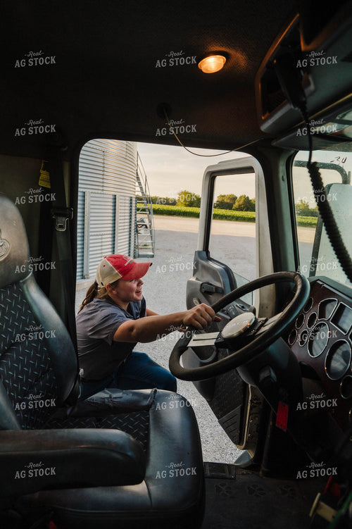 Female Farmer Climbing into Semi 115296