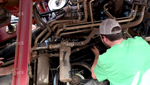 Farmer Repairing Combine - 425