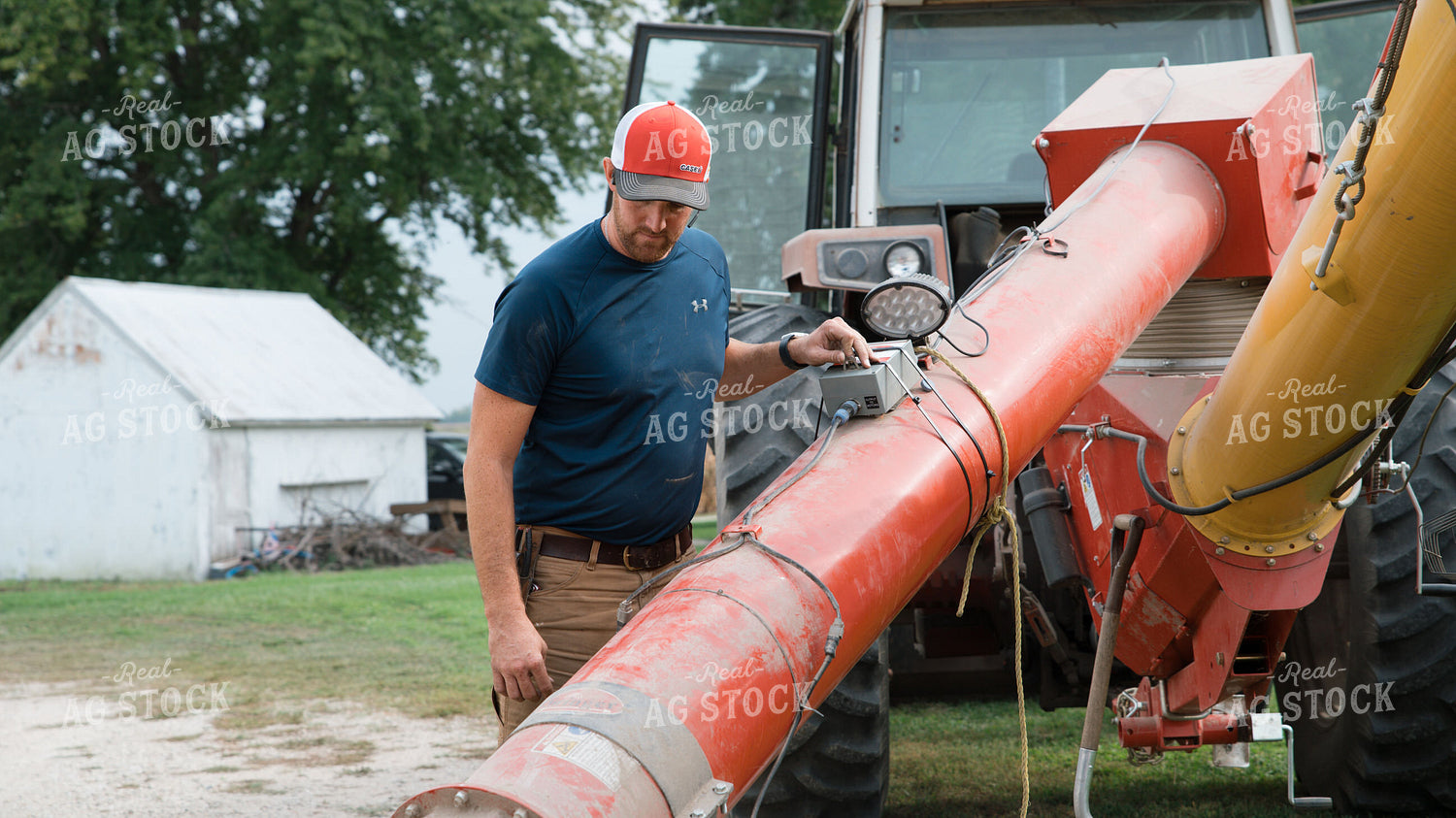 Farmer Operating Sweep Auger 26258