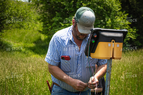 Farmer Fixing Electric Fence 214166