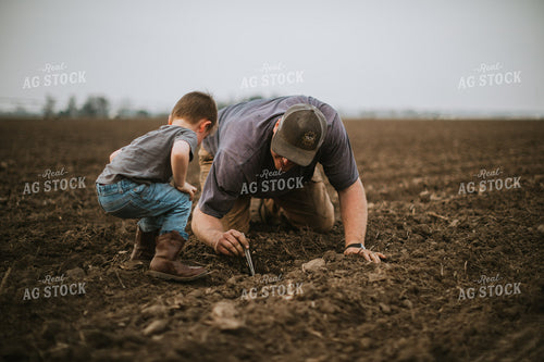 Farmer and Farm Kid Checking Seed Depth 5661