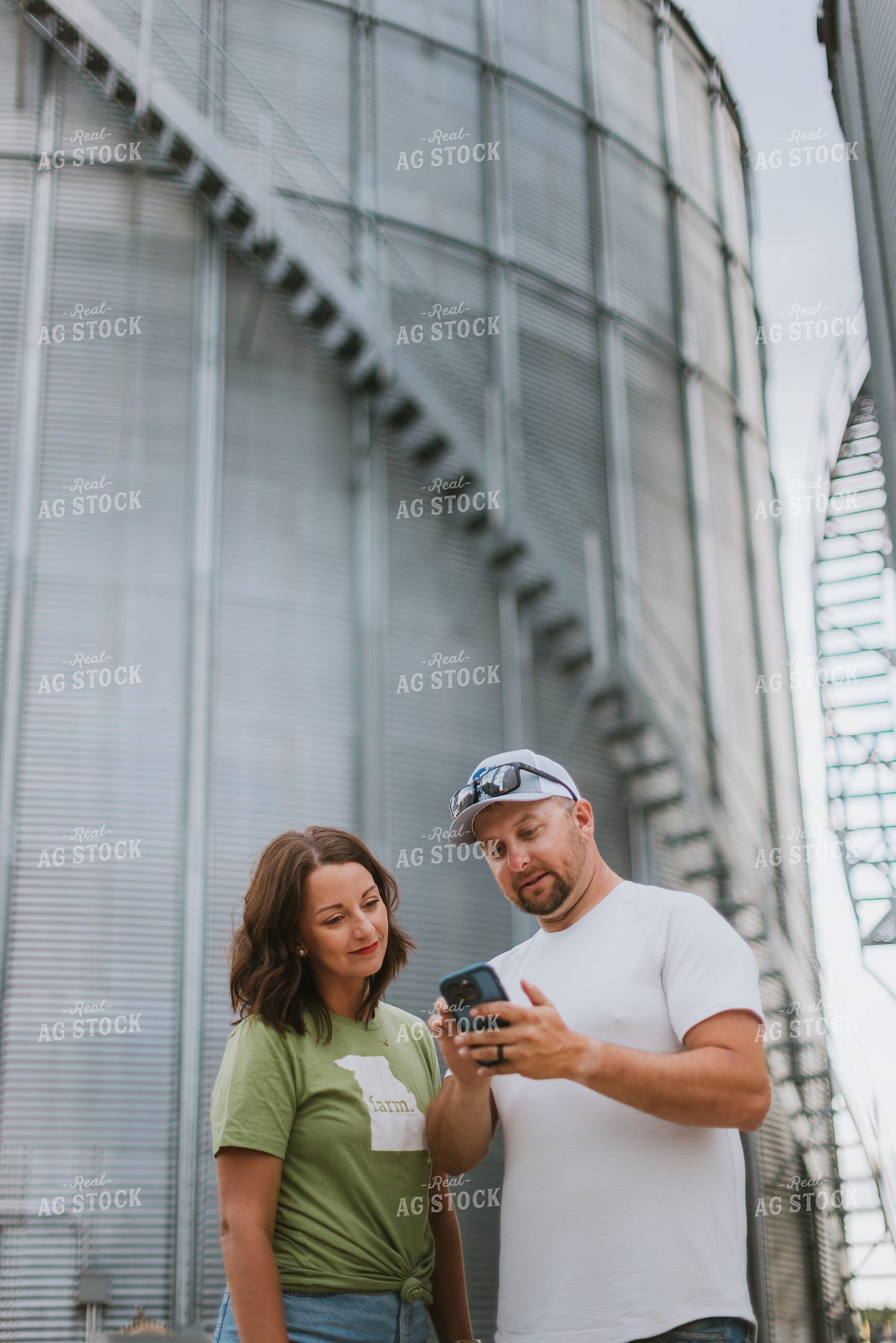 Farmer & Farm Wife Looking at Phone by Grain Bin 8772