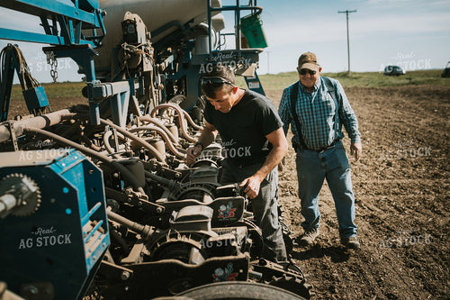 Farmers Adjusting Planter 4276
