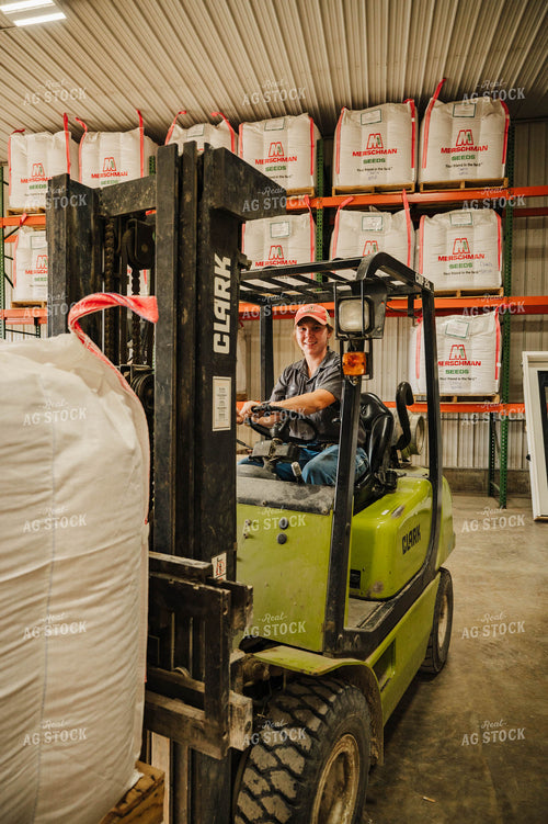 Female Farmer Driving Skid Steer 115240