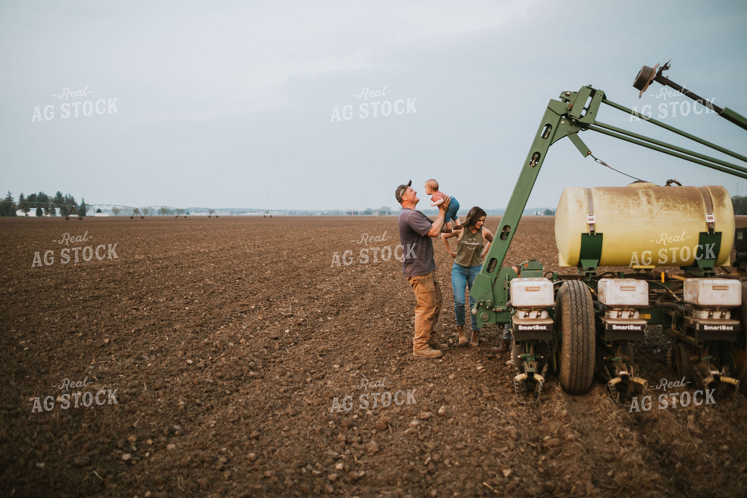 Farm Family in Field During Planting 5726