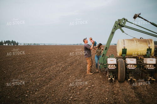 Farm Family in Field During Planting 5726