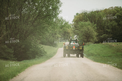 Tractor and Planter Driving Down Road 4012